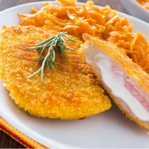 Chicken cordon bleu with grated carrots.