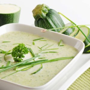 Chilled zucchini soup in a white bowl